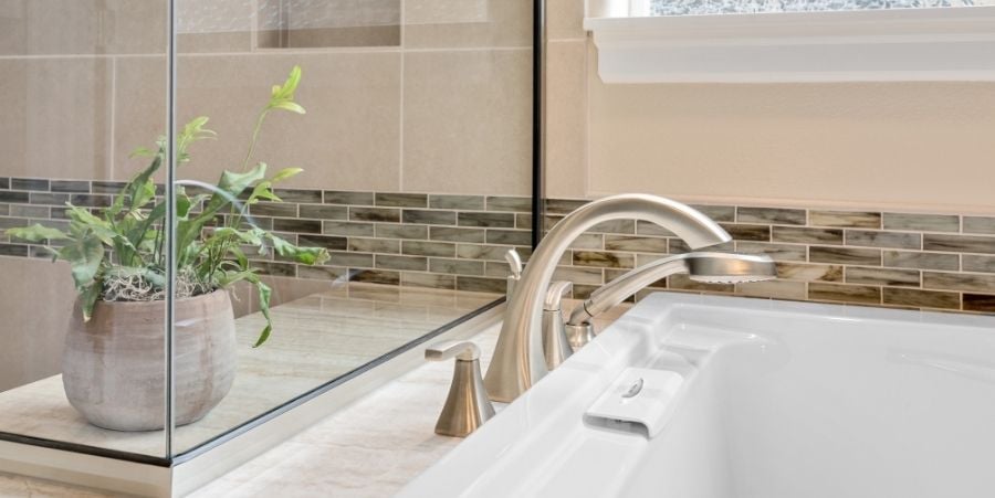 Glass Tile Along Bathroom Sink And Counter.