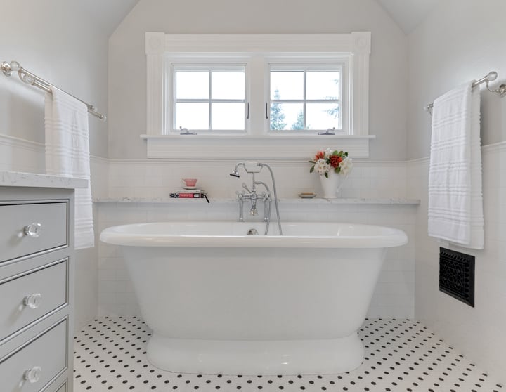 remodeled bathroom with white tile, black polka dots, and a white tub by Corvallis Custom Kitchens & Baths in Corvallis, Oregon