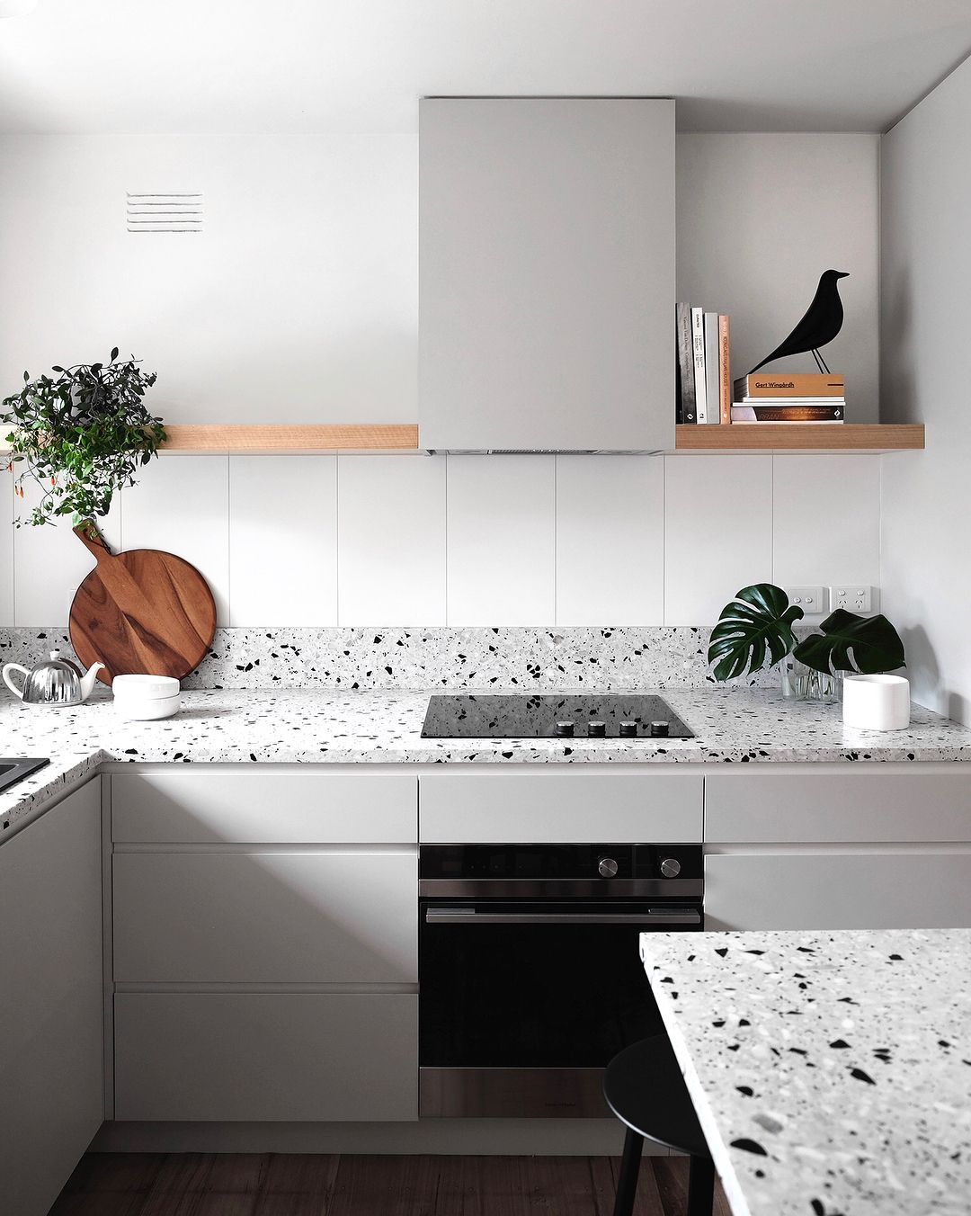 light terrazzo kitchen countertops with white cabinets - photo by designstuff on instagram