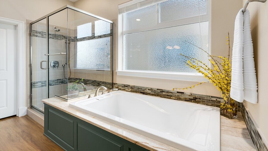 white soaker tub with green wood cabinets underneath by corvallis in oregon