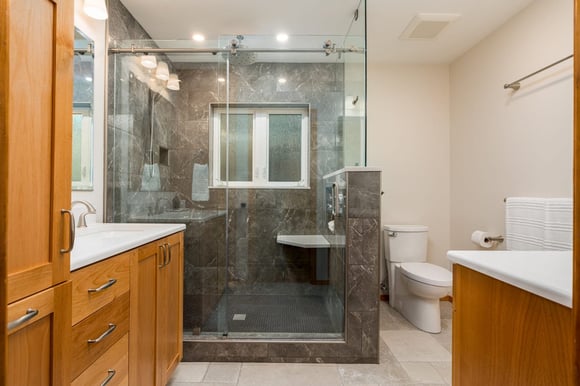 remodeled bathroom with wood cabinets and walk in shower by Corvallis Custom Kitchens & Baths in Corvallis, Oregon