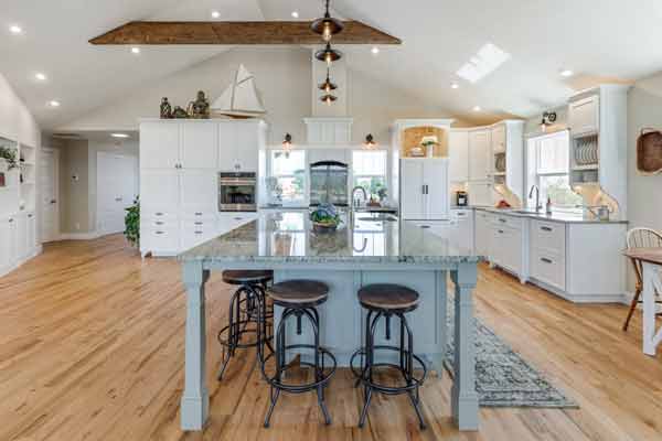 open kitchen with powered blue island and vaulted ceilings  by Corvallis Custom Kitchens & Baths in Corvallis, Oregon