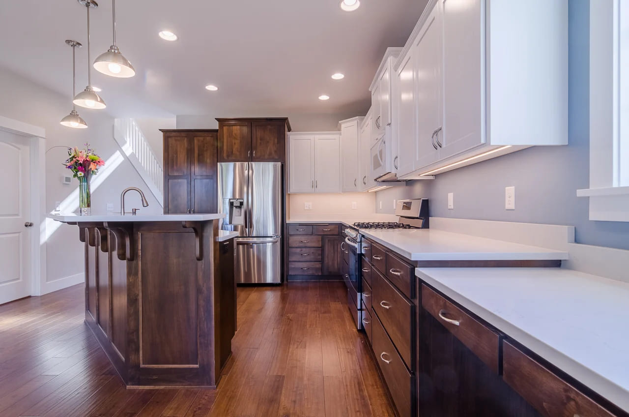 kitchen with dark brown wood cabinets and white countertops by corvallis kitchens and bathrooms