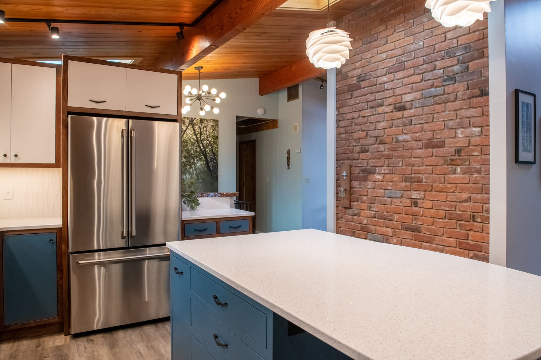 white island with fridge and brick wall in kitchen remodel by Corvallis Custom Kitchen and Baths in Corvallis, Oregon