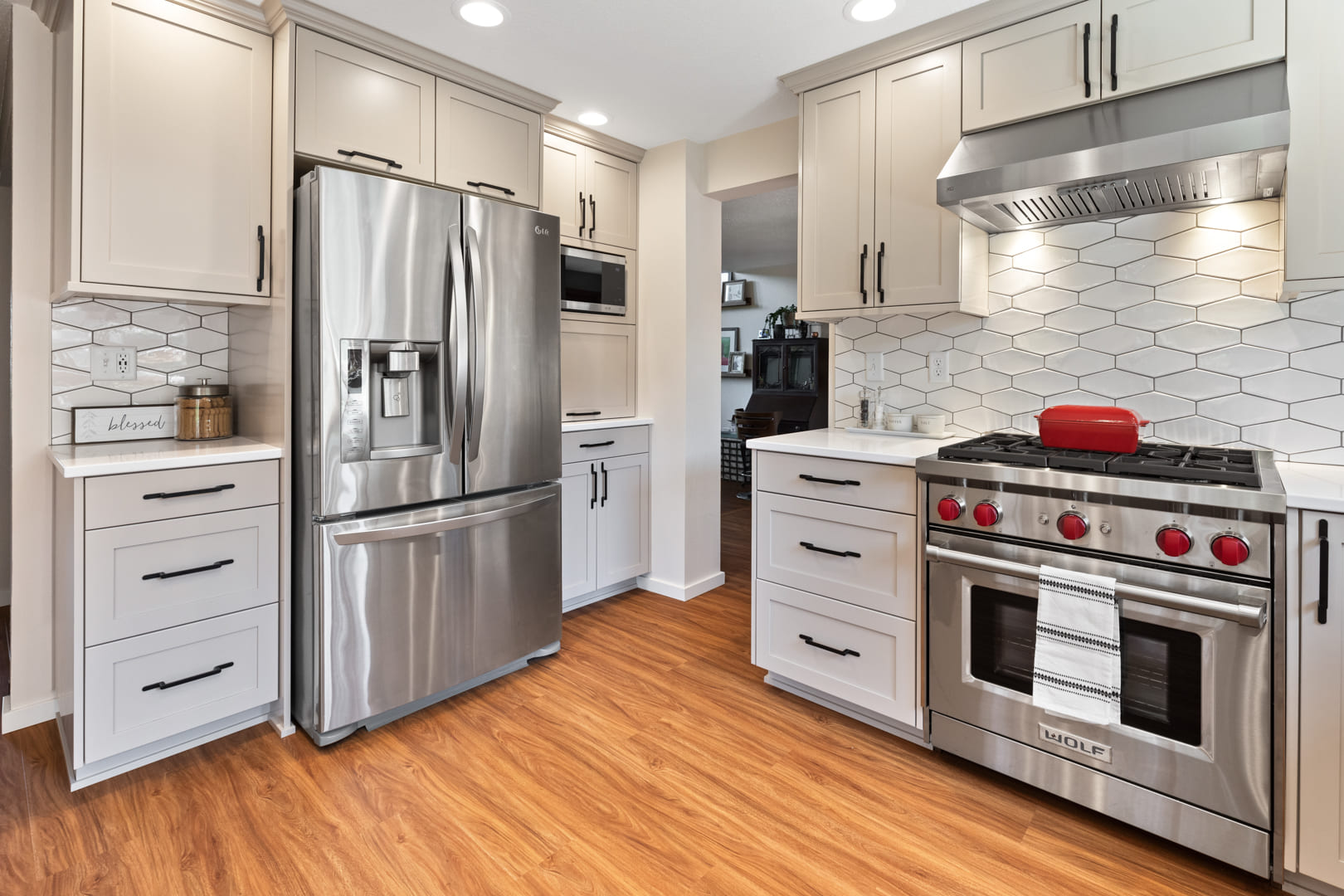stainless steel appliances, hardwood floors, and light cabinets in remodeled kitchen by corvallis custom kitchens and baths in corvallis oregon