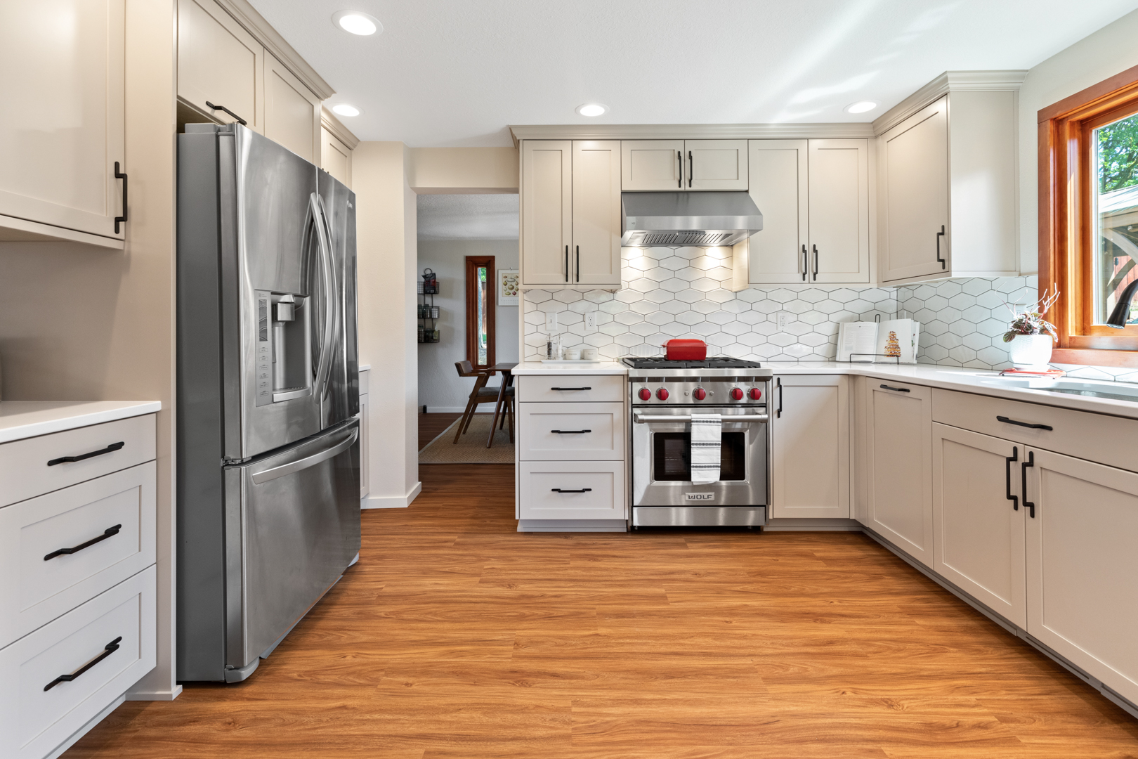 white modern kitchen with brown hardwood flooring by Corvallis Custom Kitchens & Baths in Corvallis, OR