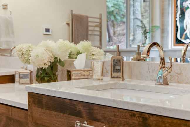 bathroom sink with gold faucet  by Corvallis Custom Kitchens & Baths in Corvallis, Oregon